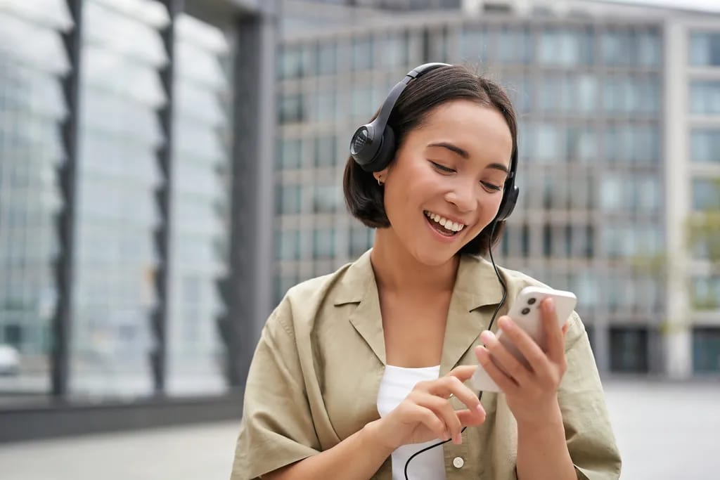 Woman with headphones using phone